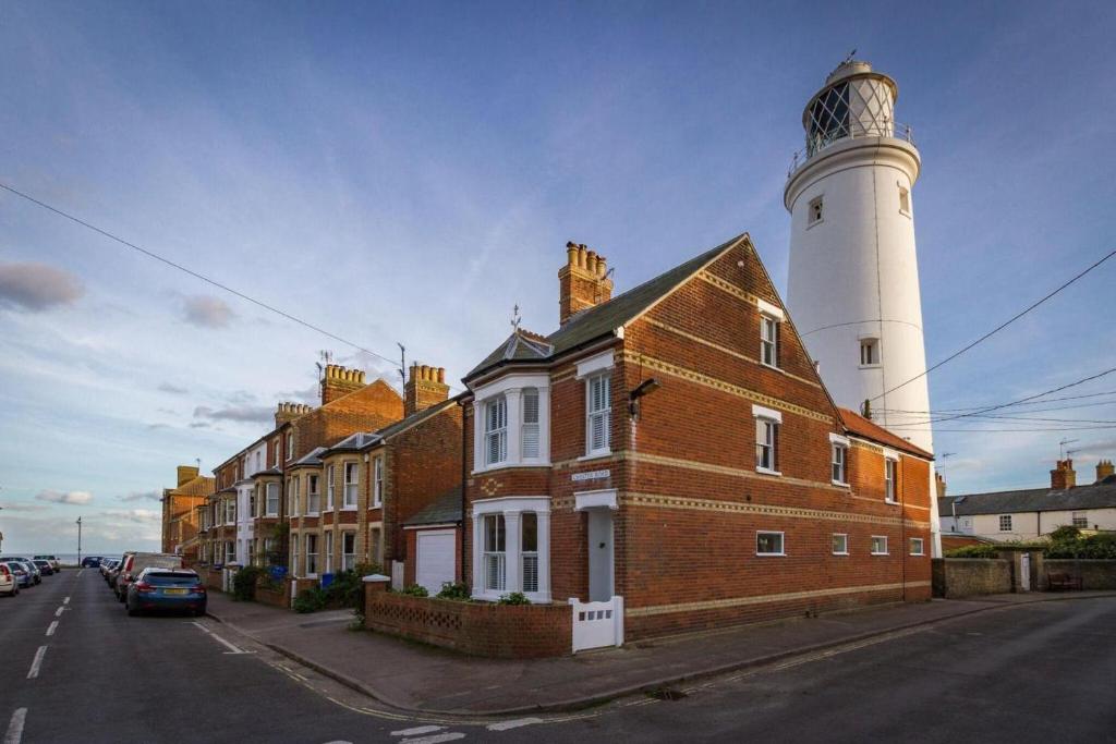 a brick building with a lighthouse on a street at 3 Bed in Southwold oc-tlw2 in Southwold