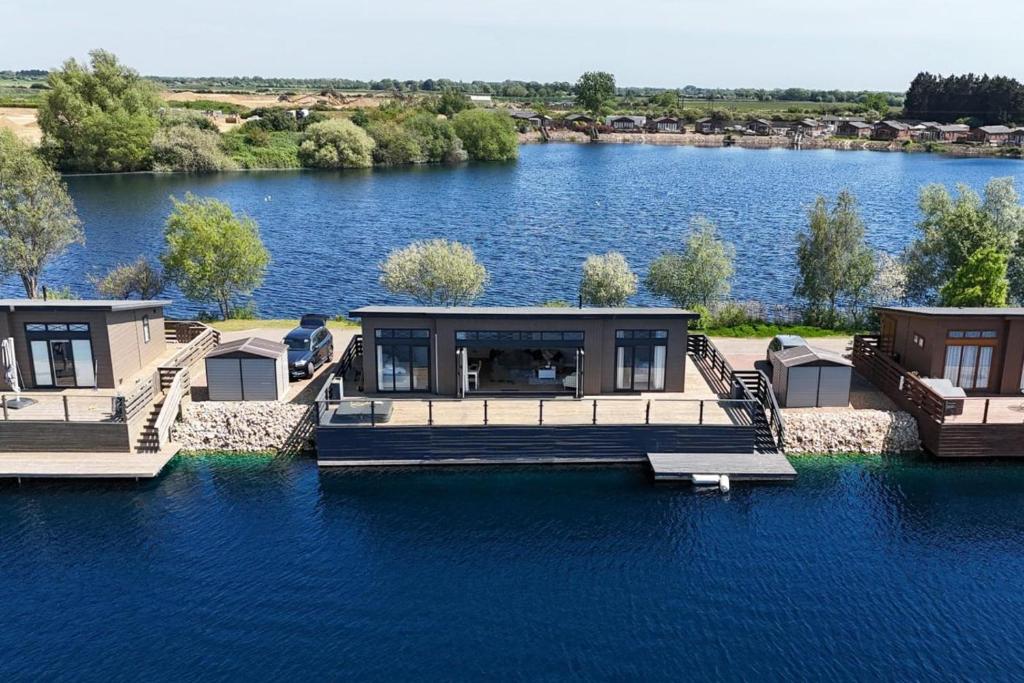 a house on the water with a dock on a lake at 2 Bed in Tallington oc-b32208 in Barholm