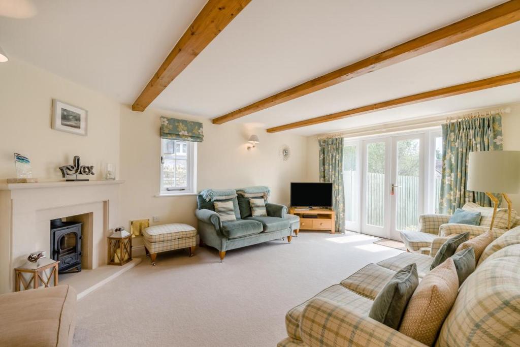 a living room with a couch and a fireplace at 3 Bed in West Lulworth oc-s32114 in West Lulworth