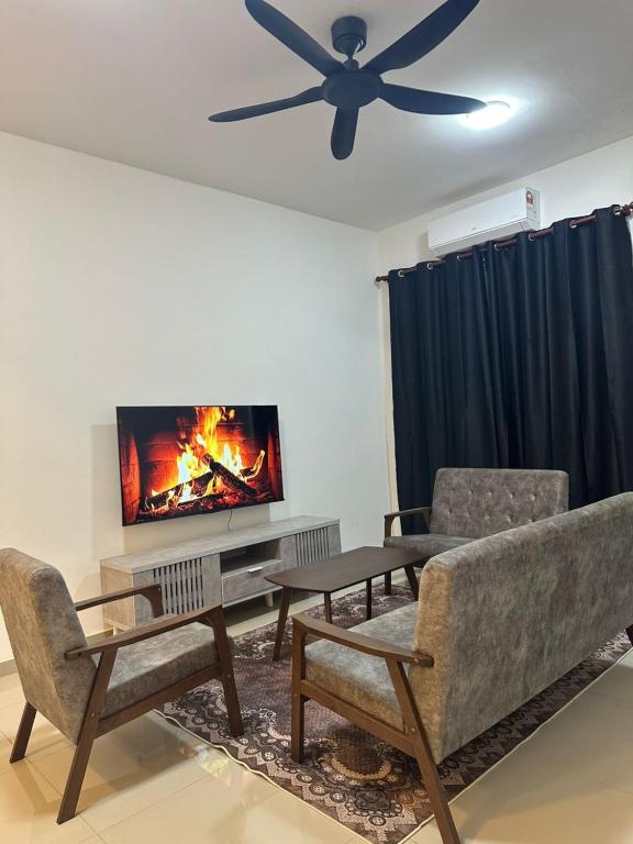 a living room with a couch and a ceiling fan at RNA Homestay Bayan in Tawau