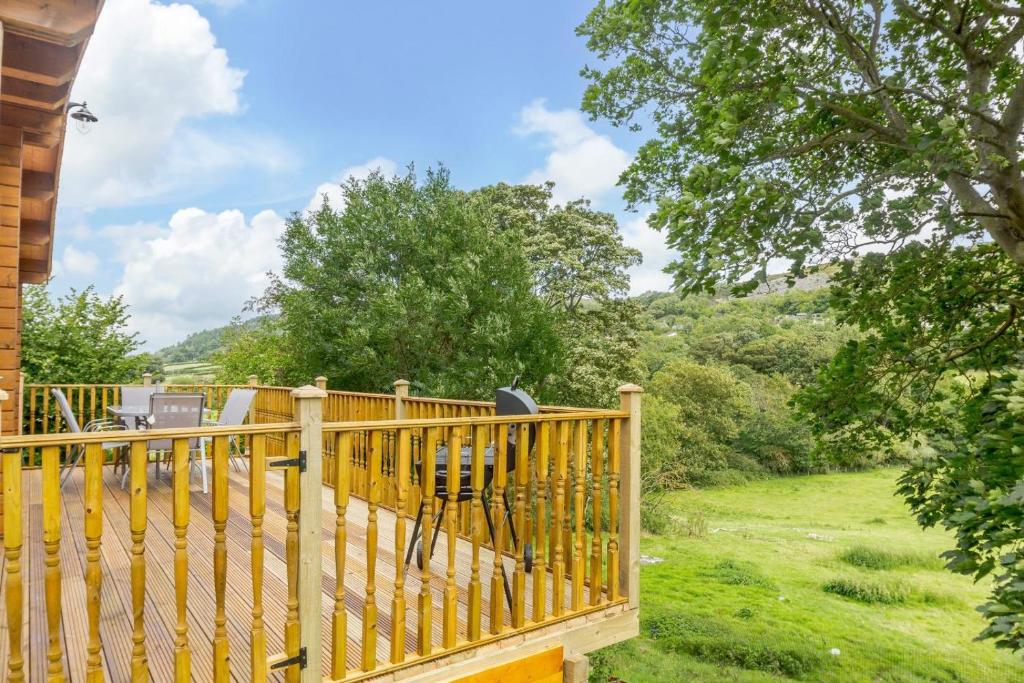 a wooden deck with a view of a yard at 3 Bed in Llanddulas oc-r27872 in Llanddulas