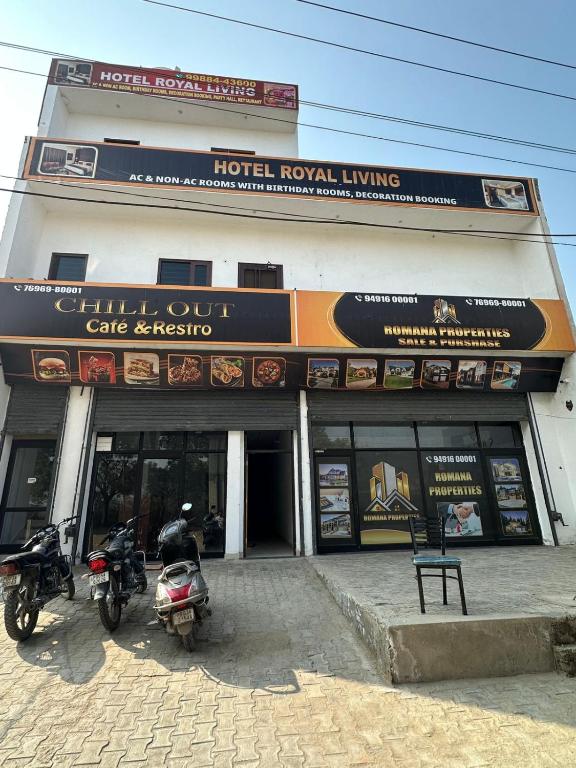a building with two motorcycles parked in front of it at Royal living hotal in Bathinda