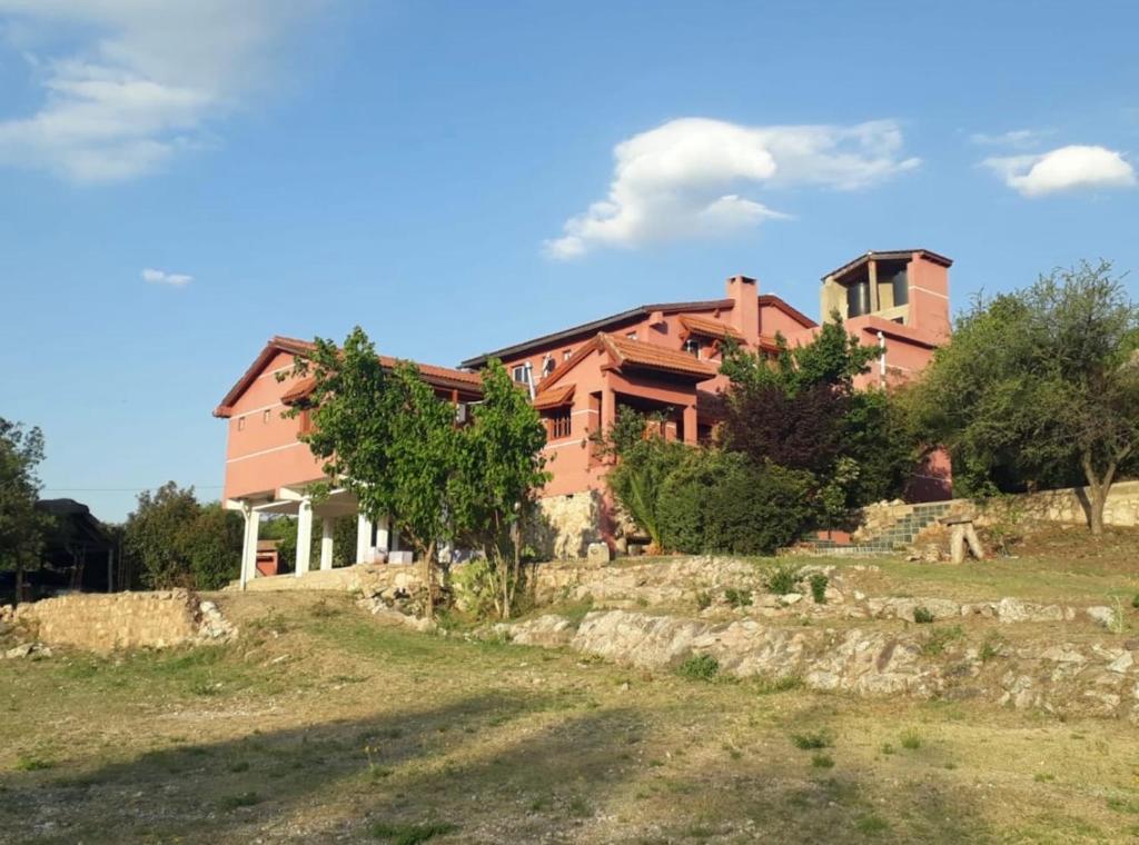 a large house on top of a grassy hill at Casona de Montaña in Los Hornillos