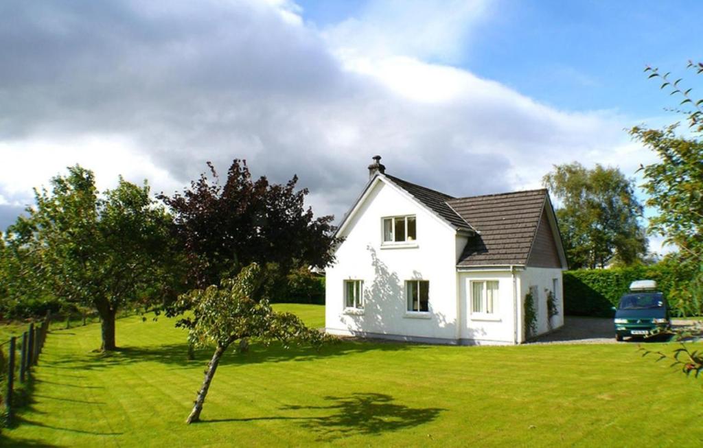 a white house with a blue truck parked in a yard at 3 Bed in North Connel oc-a29963 in Connel