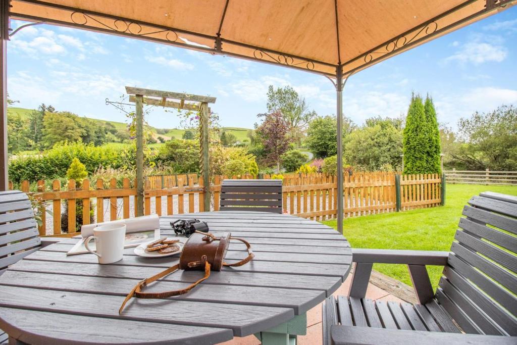a wooden table with a purse sitting on a patio at 2 Bed in Devils Bridge oc-d29575 in Devils Bridge