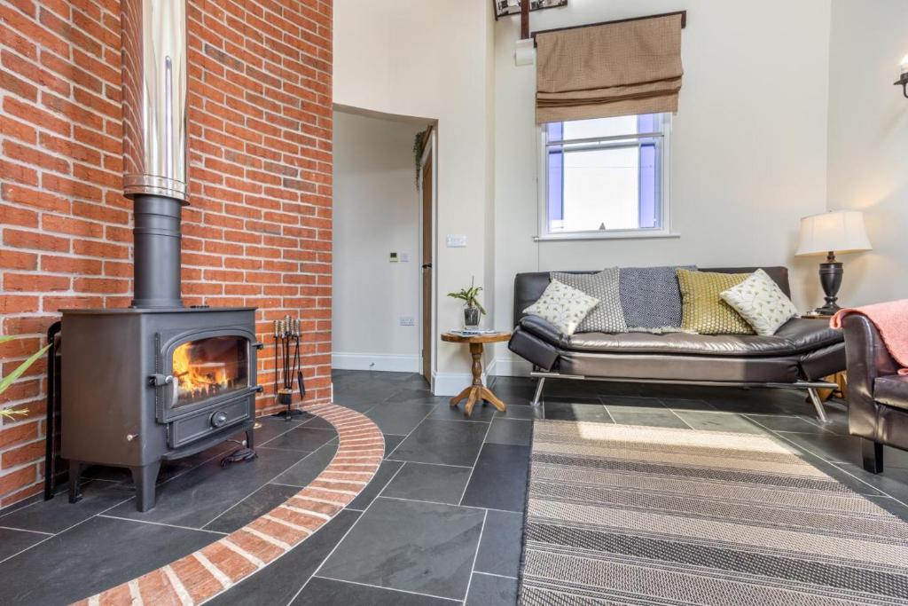 a living room with a brick wall and a fireplace at 1 Bed in Toynton All Saints oc-s29840 in Toynton All Saints