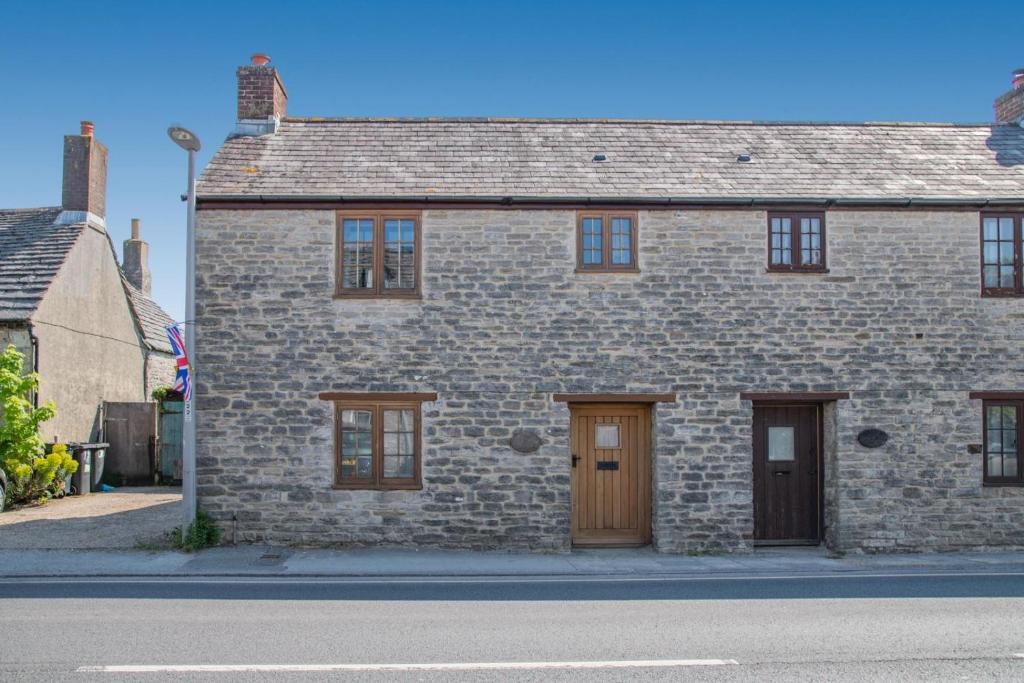 a brick house with two doors on a street at 2 Bed in Corfe Castle oc-a30970 in Corfe Castle