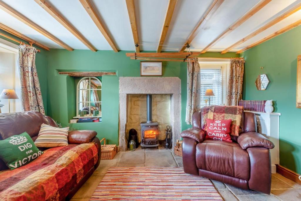 a living room with a couch and a fireplace at 1 Bed in Starkholmes oc-q30994 in Matlock Bank