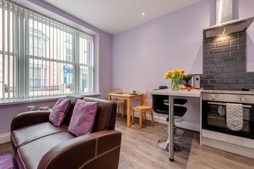 a living room with a couch and a stove at 1 Bed in Tenby oc-w28984 in Tenby