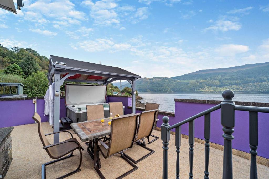 a deck of a house with a table and chairs at 4 Bed in Lochgoilhead oc-j30107 in Carrick