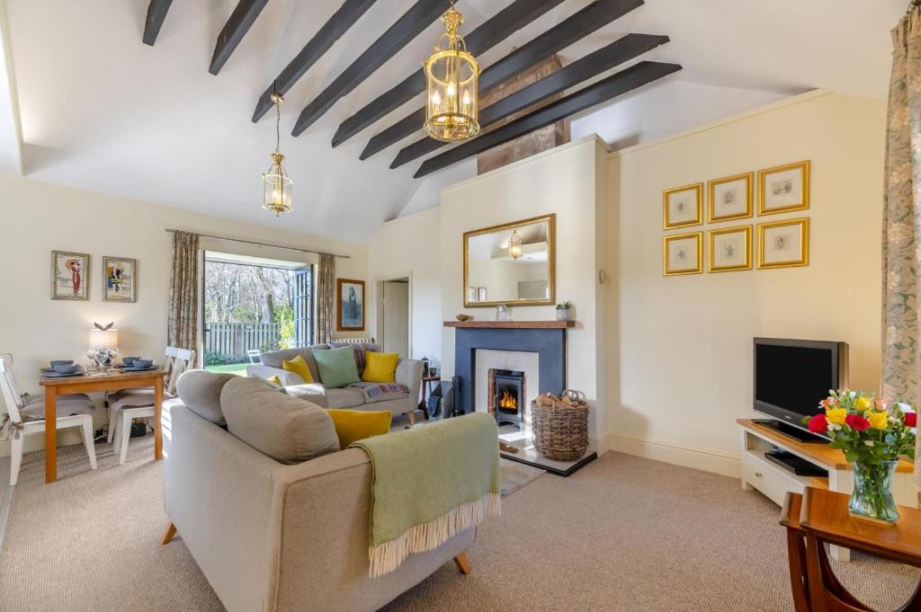 a living room with a couch and a fireplace at 2 Bed in Cornhill-on-Tweed oc-d30765 in Cornhill-on-tweed
