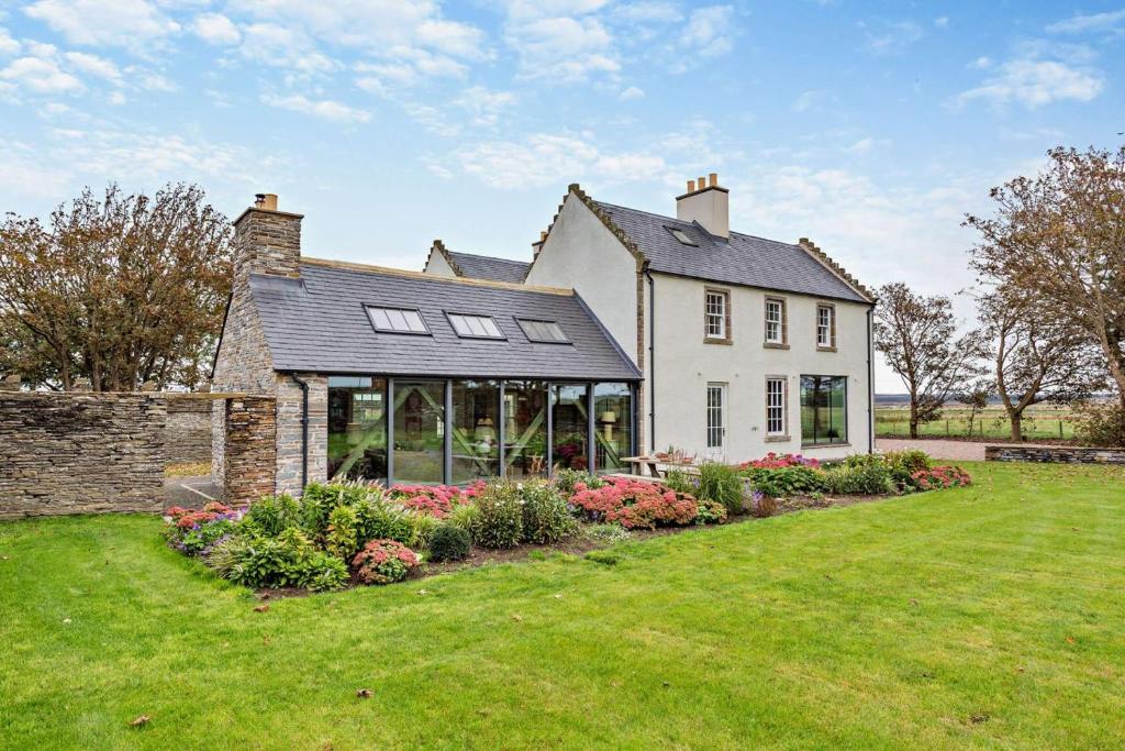 a large white house with a large yard at 3 Bed in Scarfskerry oc-o30016 in Scarfskerry