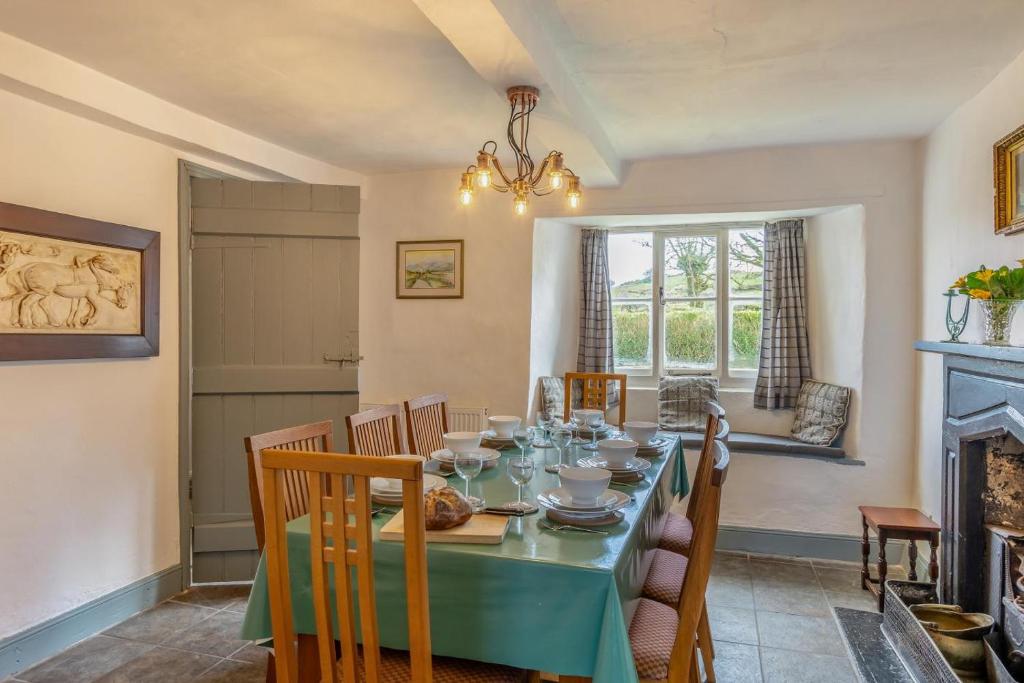 a dining room with a table and a fireplace at 3 Bed in Windermere oc-b31667 in Crook