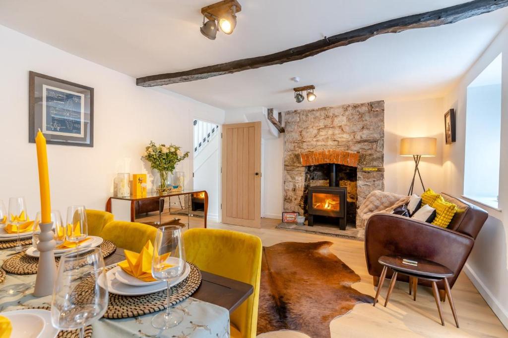 a living room with a table and a fireplace at 3 Bed in Crickhowell oc-r32122 in Crickhowell