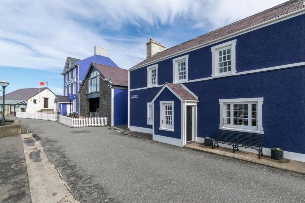 a blue house with a bench in front of it at 2 Bed in Aberaeron oc-bow173 in Aberaeron