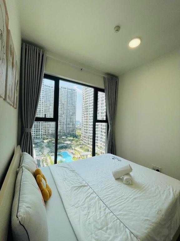 a bedroom with a large bed with a large window at 2 Bedrooms Masterise Center Point C Vinhomes Grand Park in Long Bình