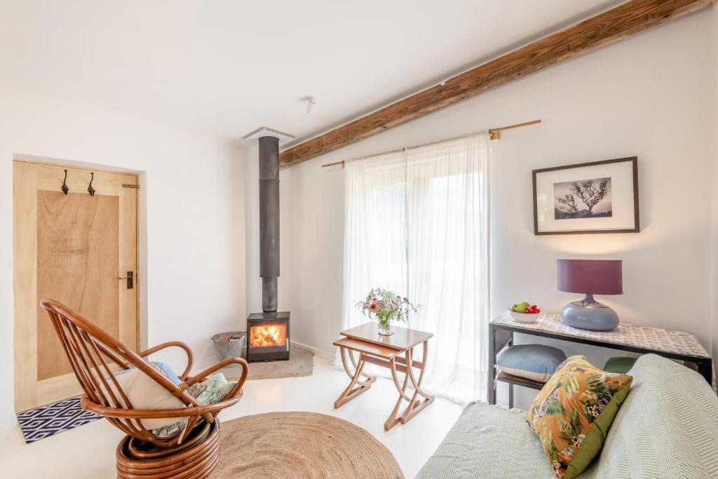 a living room with a couch and a wood stove at 1 Bed in Luddenham oc-s32602 in Luddenham