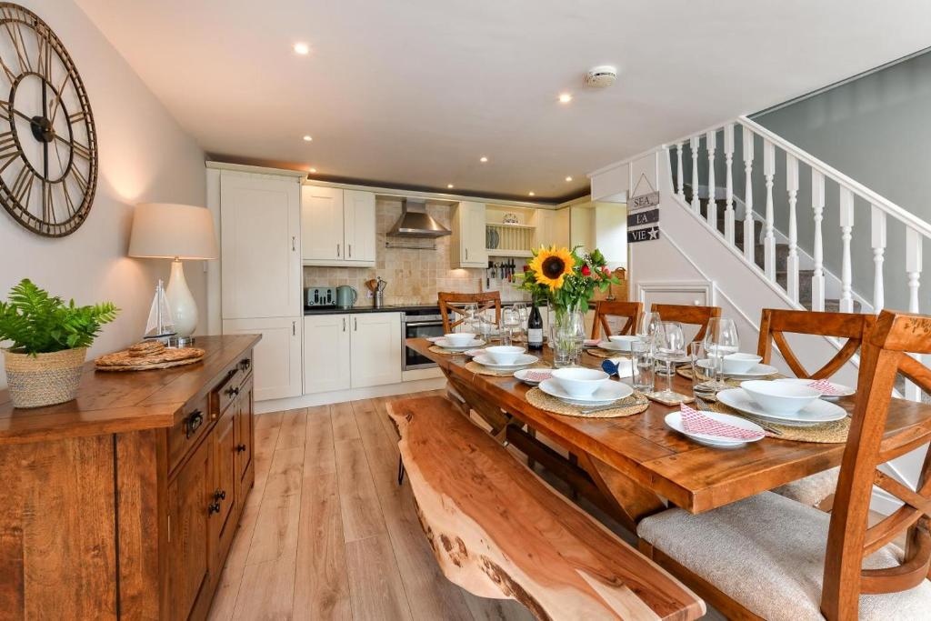 a dining room with a wooden table and a kitchen at 3 Bed in Abersoch oc-egrynb in Abersoch