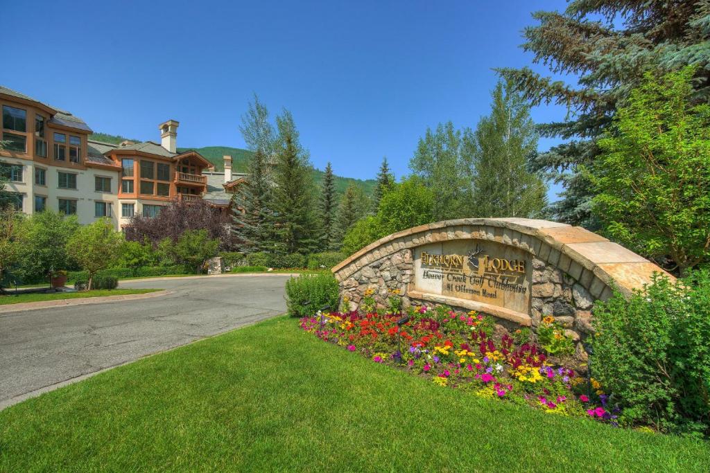a sign for a park with flowers in a yard at Elkhorn Lodge, A Vail Resorts Property in Avon
