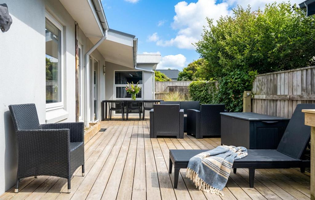 a patio with chairs and tables on a deck at Awesome Home In Thyborøn With Wifi in Thyborøn
