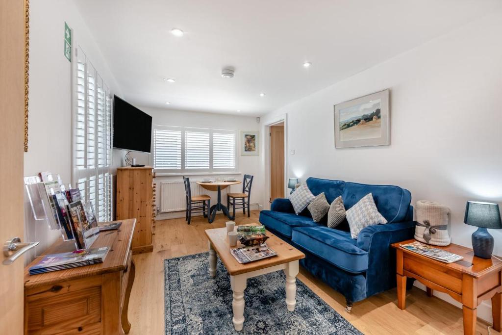 a living room with a blue couch and a table at 1 Bed in Yapton oc-b32757 in Yapton