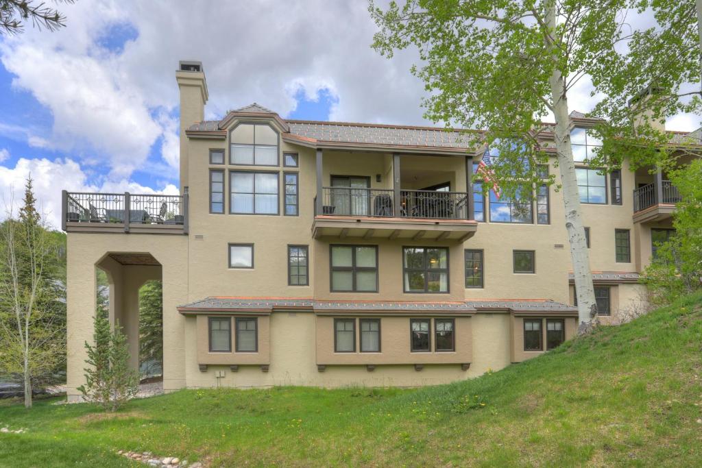 a large house on a hill with trees in front of it at Beaver Creek Village by Vail Resorts in Avon