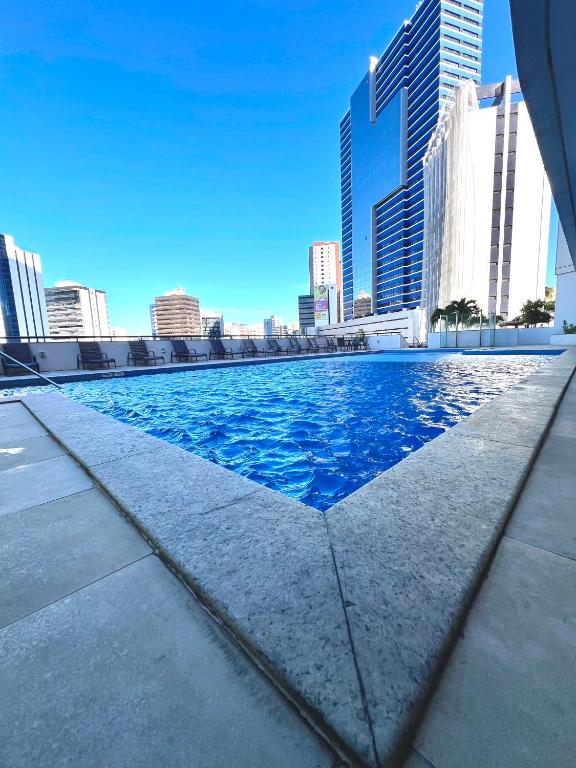 a swimming pool in the middle of a city skyline at Mercure1906 - Piscina aquecida, edifício com estrutura de hotel 4 estrelas in Salvador