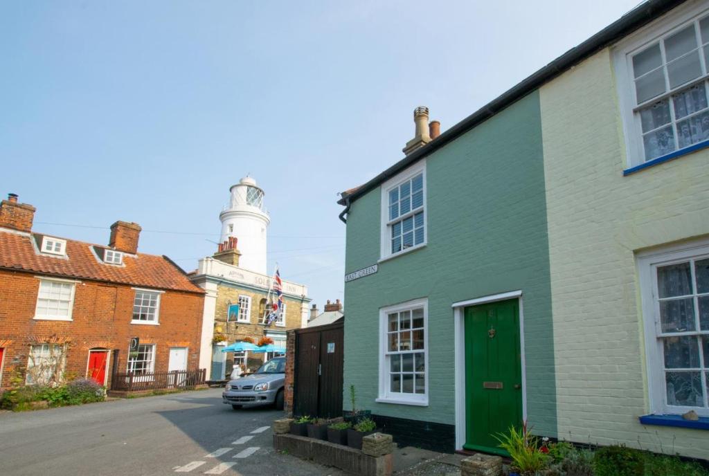 a row of houses on a street with a lighthouse at 2 Bed in Southwold oc-eastgn in Southwold