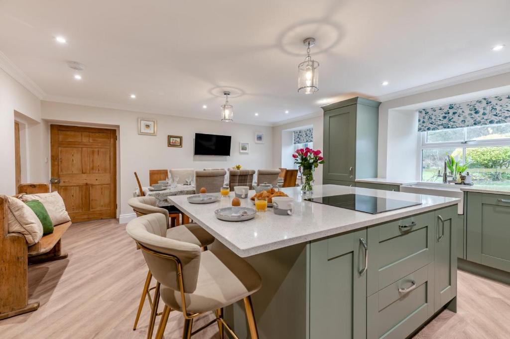 a kitchen and living room with a table and chairs at 5 Bed in Biddlestone oc-b30105 in Alnham