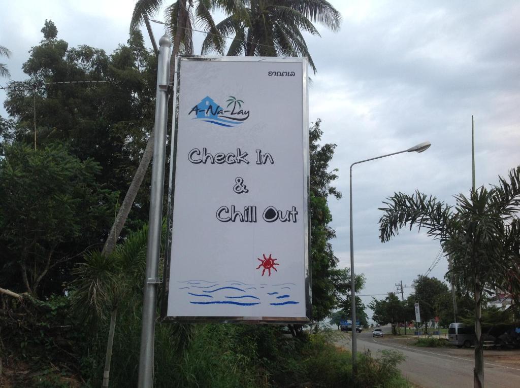 a sign that reads check in and chill out at Check In and Chill Out in Ban Laem Sok