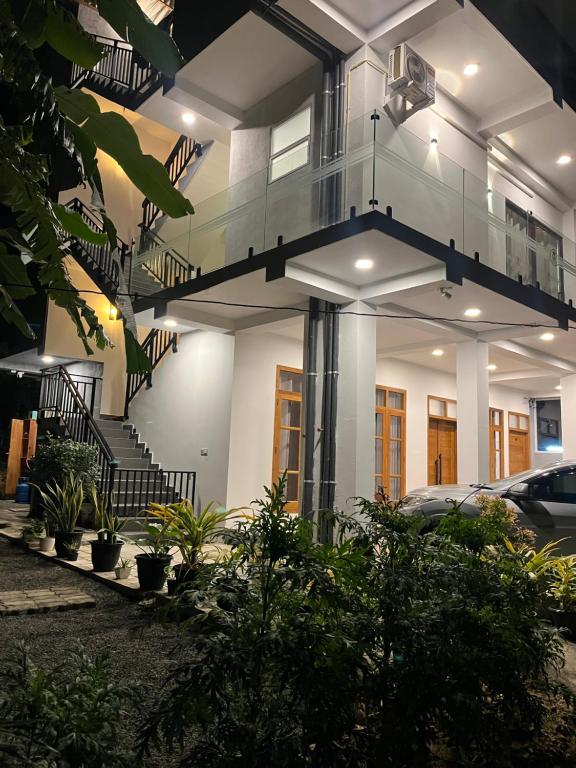 a house with a spiral staircase in front of it at Crossing Royal in Mirissa