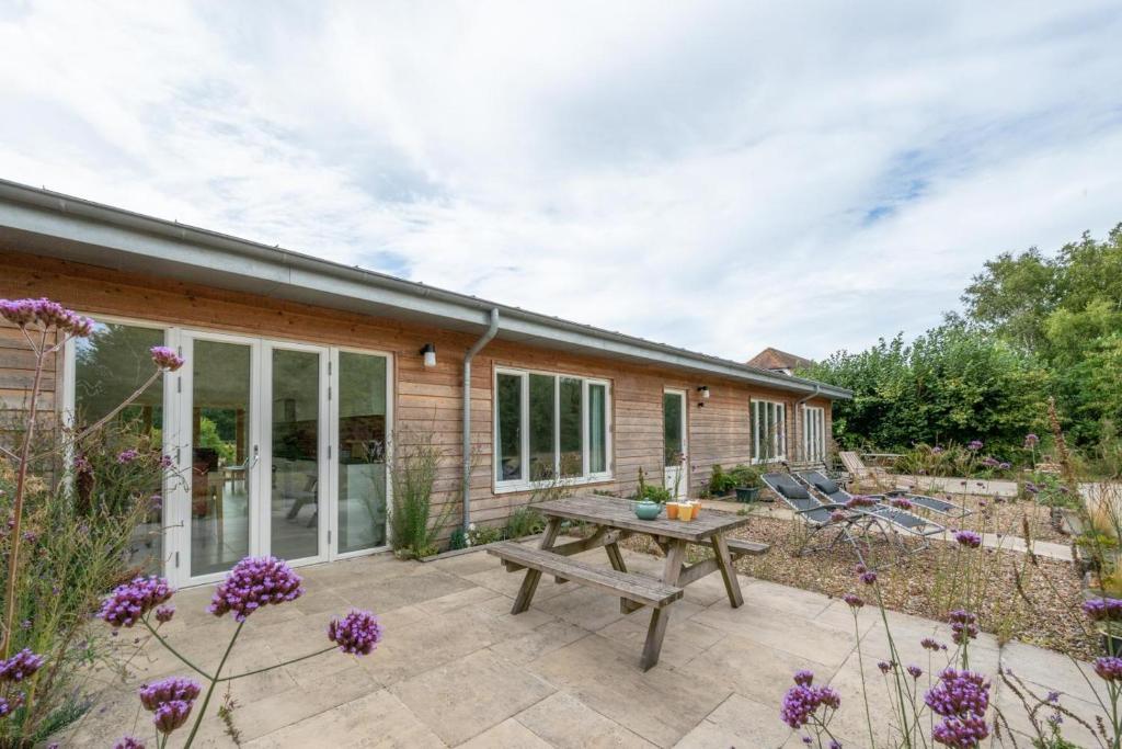 a patio with a picnic table in front of a house at 2 Bed in Stelling Minnis oc-ek715 in Lyminge