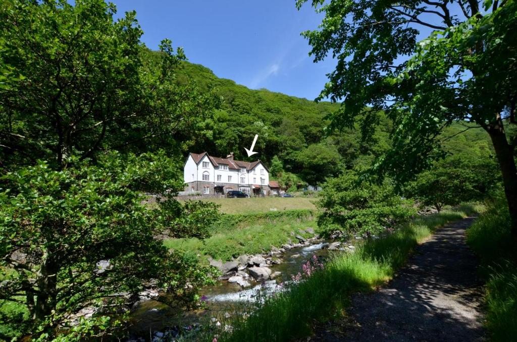 a house on a hill next to a river at 4 Bed in Lynmouth oc-marins in Barbrook