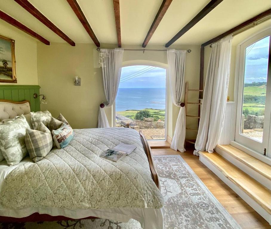 a bedroom with a bed and a large window at 3 Bed in Scarborough oc-sa004 in Ravenscar
