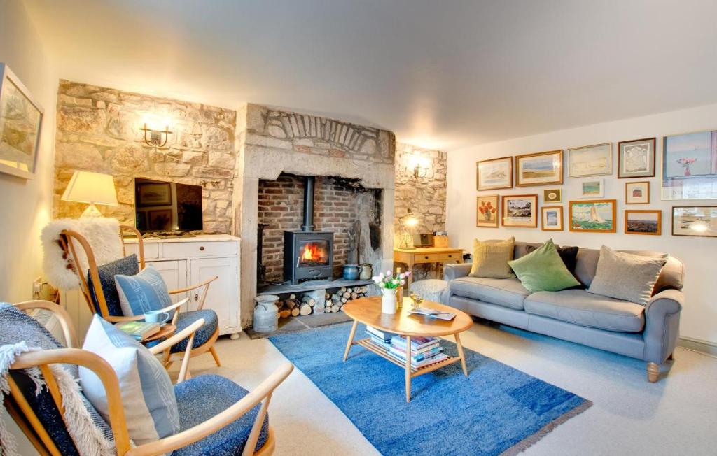 a living room with a couch and a fireplace at 2 Bed in Bamburgh oc-gd0248 in Bamburgh