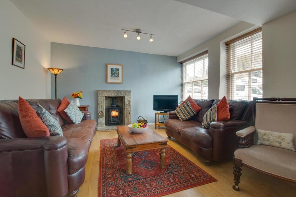 a living room with leather couches and a coffee table at 4 Bed in Buxton oc-dcjar in Tideswell