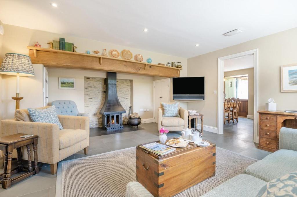 a living room with a fireplace and a tv at 3 Bed in Withypool oc-o18550 in Withypool