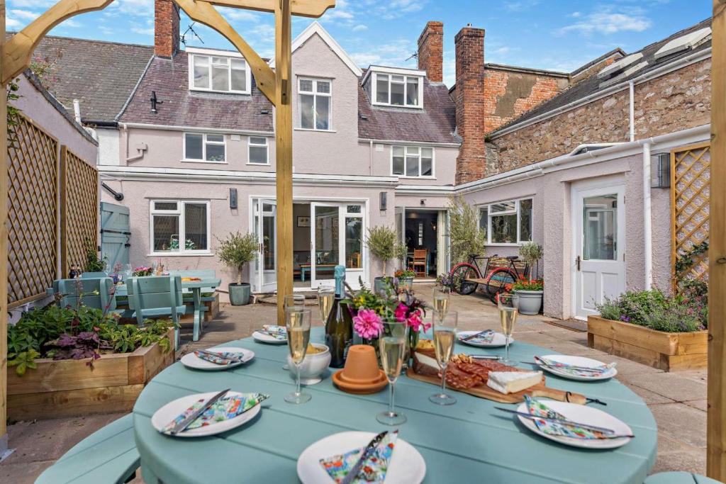 a blue table with plates of food on a patio at 4 Bed in Ruthin oc-a29543 in Ruthin