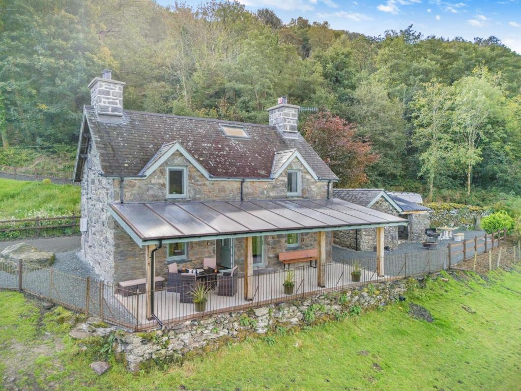 an aerial view of a stone house with a deck at 2 Bed in Penmaenpool oc-m30050 in Arthog