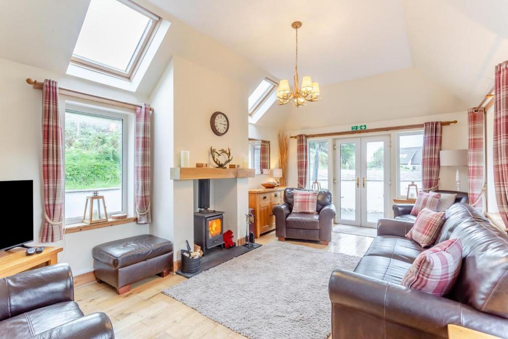 a living room with a couch and a fireplace at 3 Bed in Isle Of Skye oc-r31786 in Broadford
