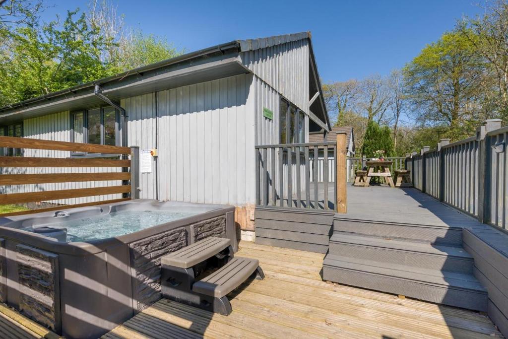 a hot tub on a deck next to a building at 2 Bed in Bush oc-b31845 in Bude