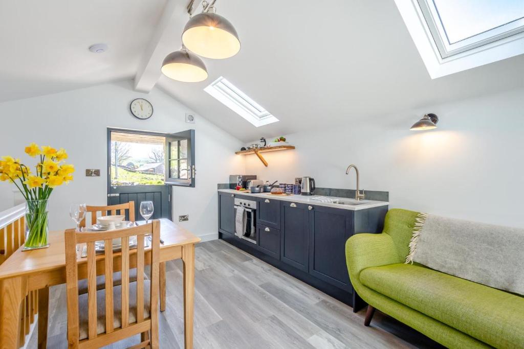 a kitchen and living room with a couch and a table at 1 Bed in Austwick oc-b31906 in Horton in Ribblesdale