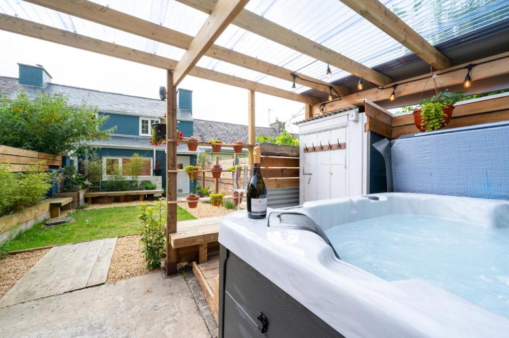a hot tub in a backyard with a pergola at 2 Bed in Aberaeron oc-bow329 in Aberaeron