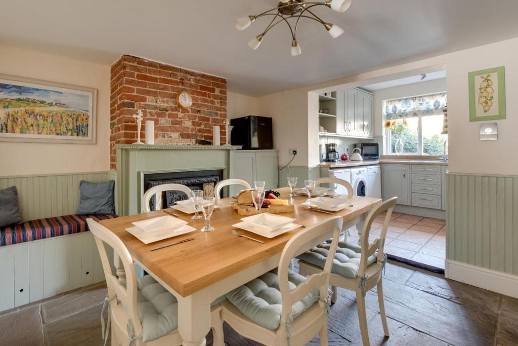 a kitchen and dining room with a wooden table and chairs at 4 Bed in Southwold oc-30vs in Southwold