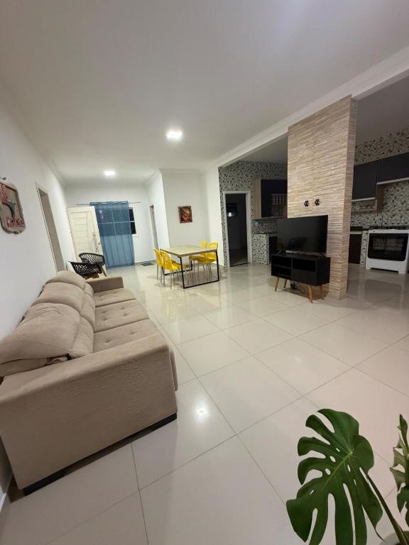 a living room with a couch and a piano at Pipa House Center in Pipa