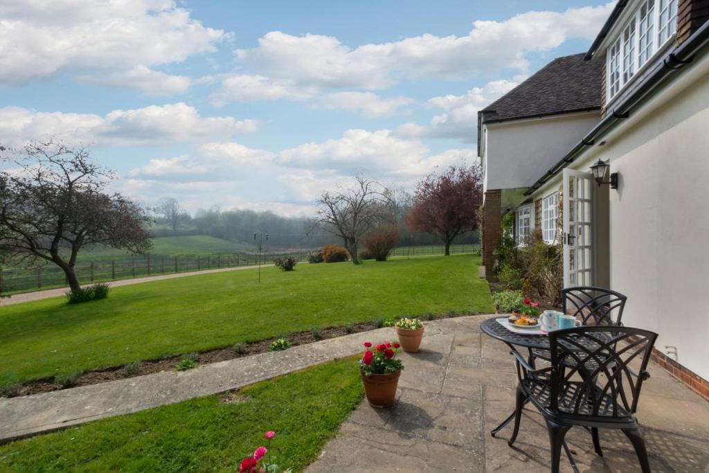 a patio with a table and chairs and a field at 1 Bed in Tenterden oc-tn623 in Saint Michaels