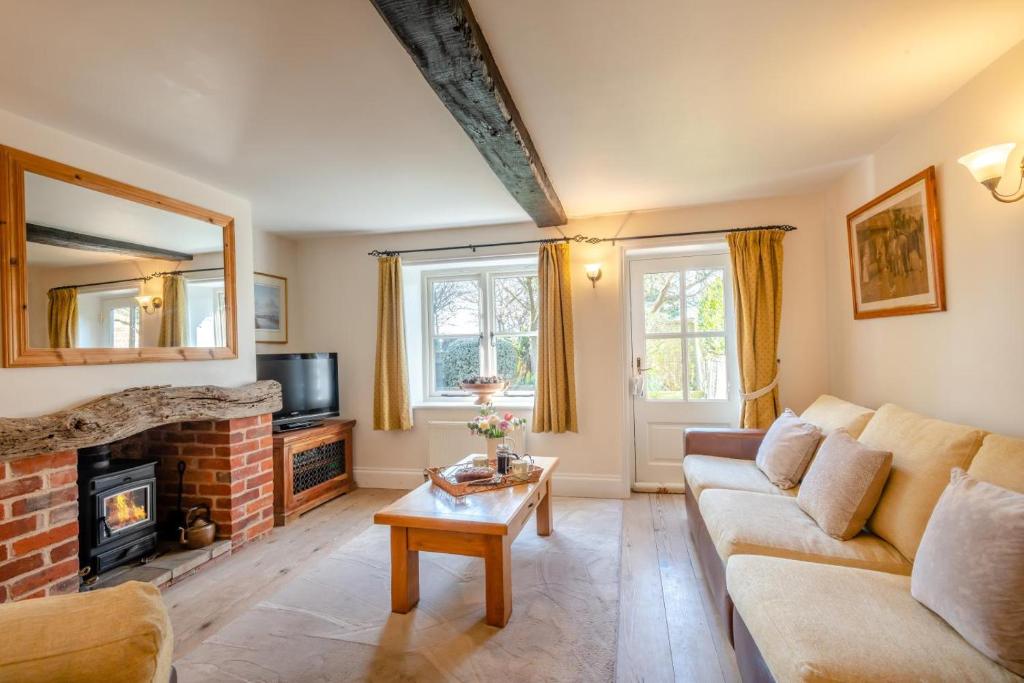 a living room with a couch and a fireplace at 2 Bed in Upton oc-867 in Upton