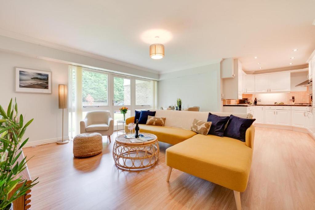 a living room with a yellow couch and a table at 2 Bed in Carlyon Bay oc-crinni in Carlyon Bay