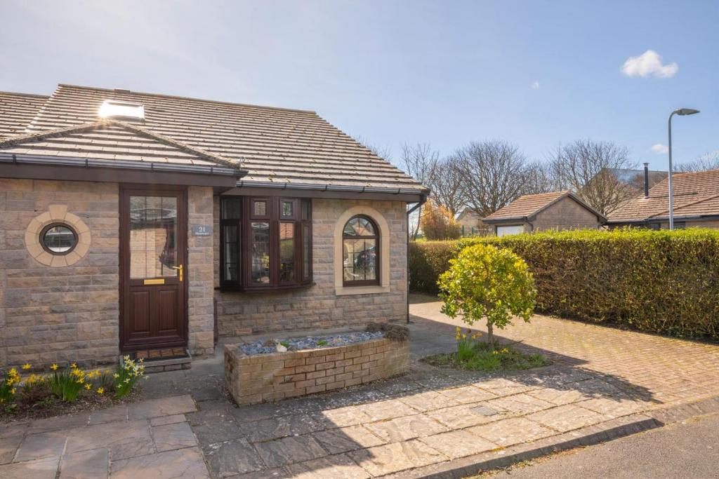 a small brick house with a brown door at 2 Bed in Seahouses oc-nb1974 in North Sunderland