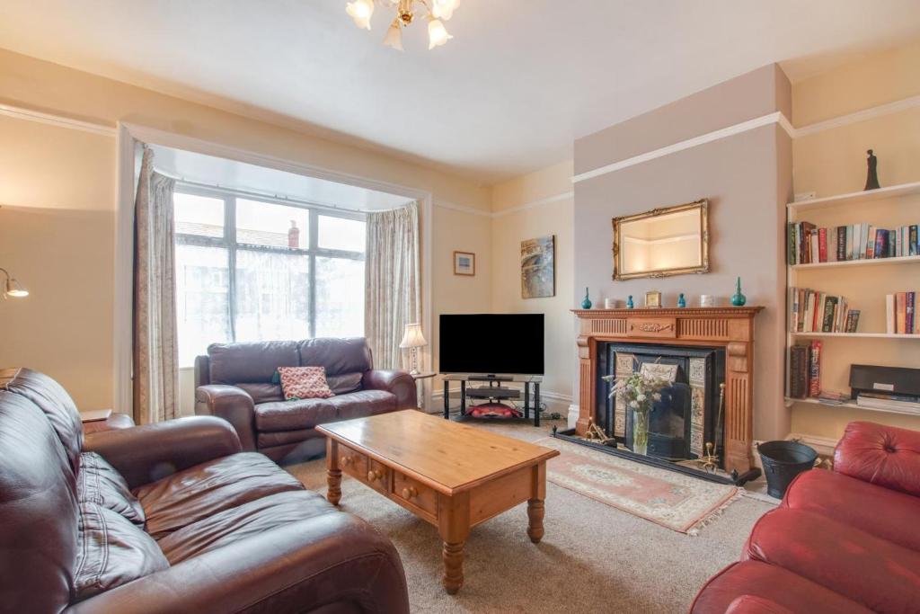 a living room with a couch and a fireplace at 5 Bed in Runswick oc-wa326 in Runswick